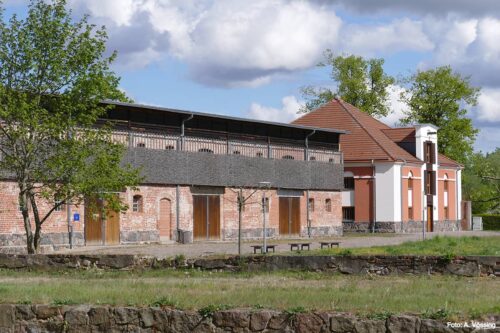 Visitor information center (former sheepfold) and village community center (former granary)